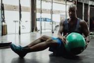 Russian twists are a great way to target your obliques. (Image via Pexels/Ketut Subiyanto)